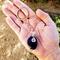 Handmade Amethyst keychain with silver wire, shown resting in an open hand for scale.
